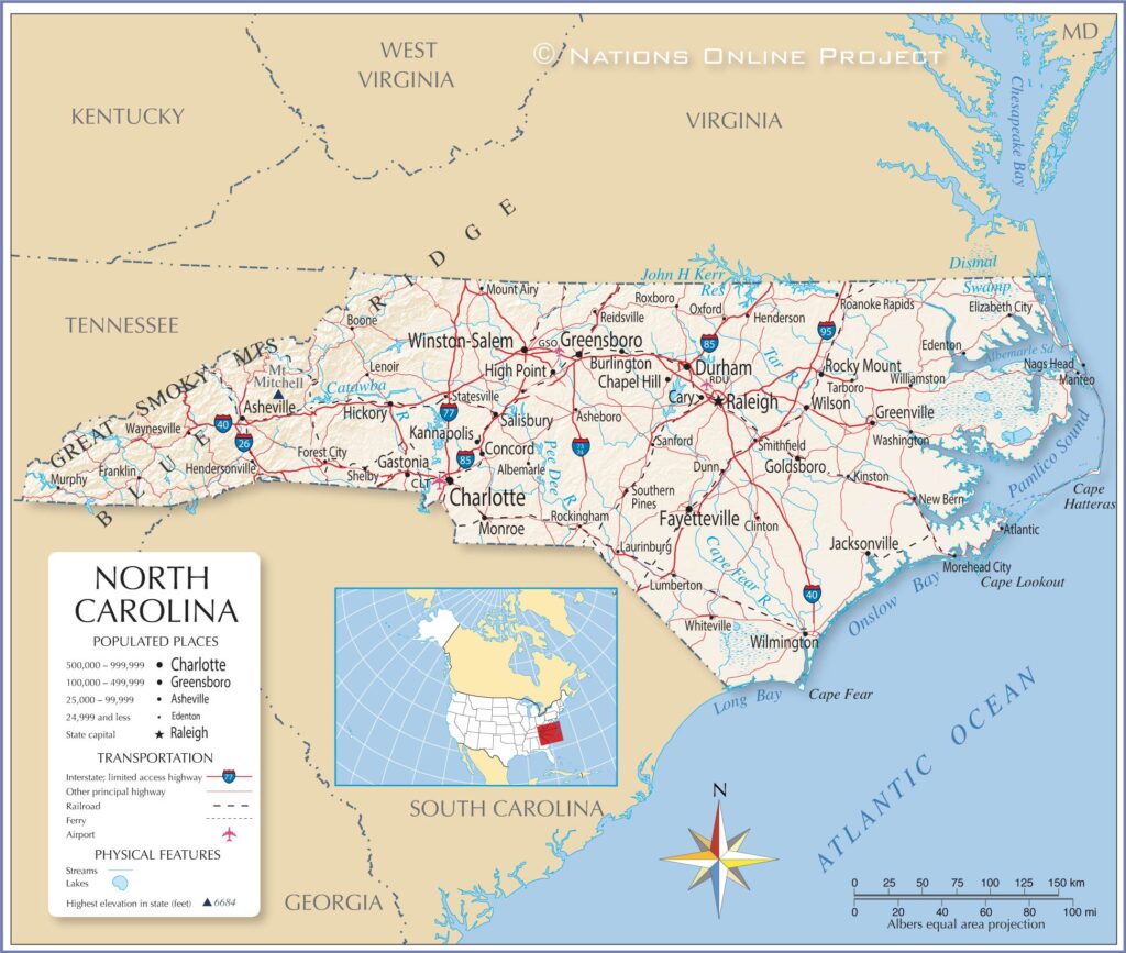 Teacher guiding student with North Carolina map in classroom